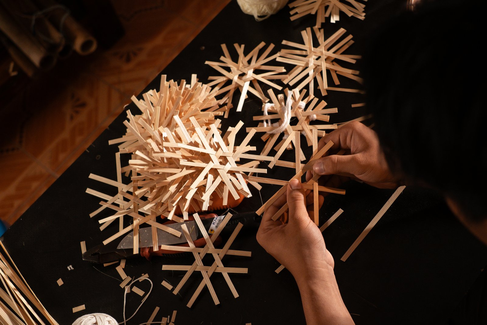Woven bamboo star ornaments laid on dark cloth